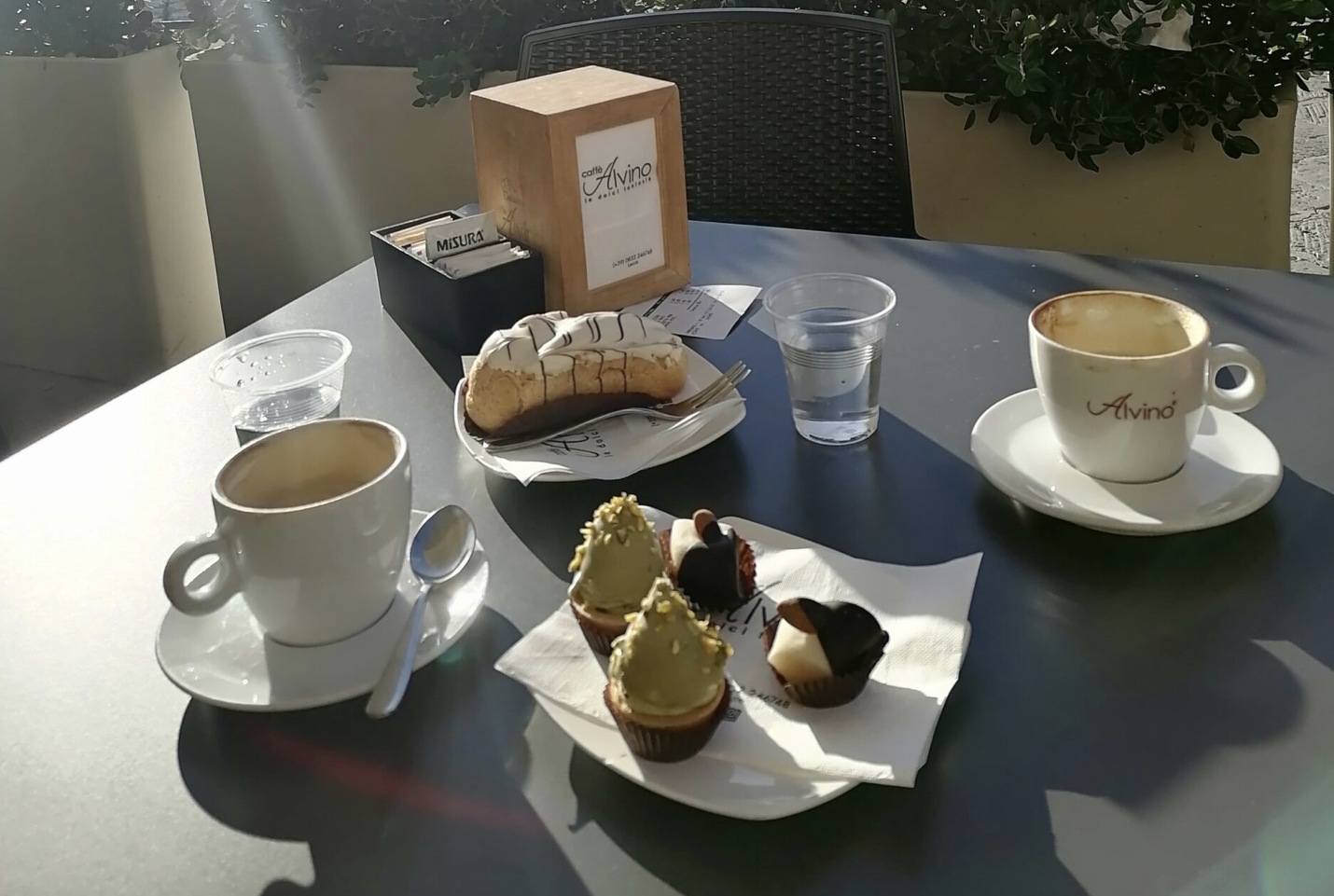 In the picture there are some cakes and coffee.