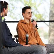 Two people sitting on stage