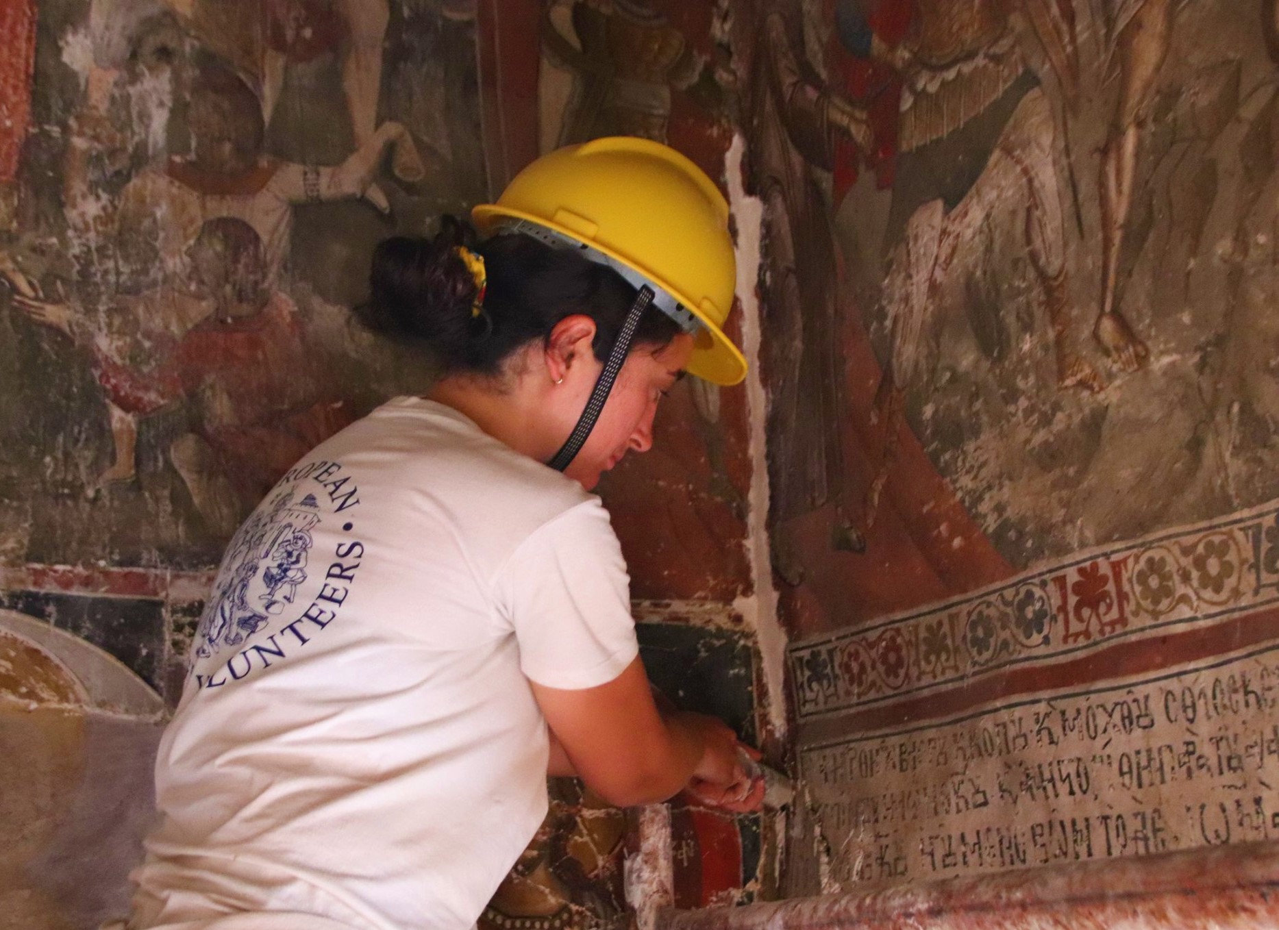 Participant working on the consolidation of plasters inside a cave church in Prespa Lake, Albania