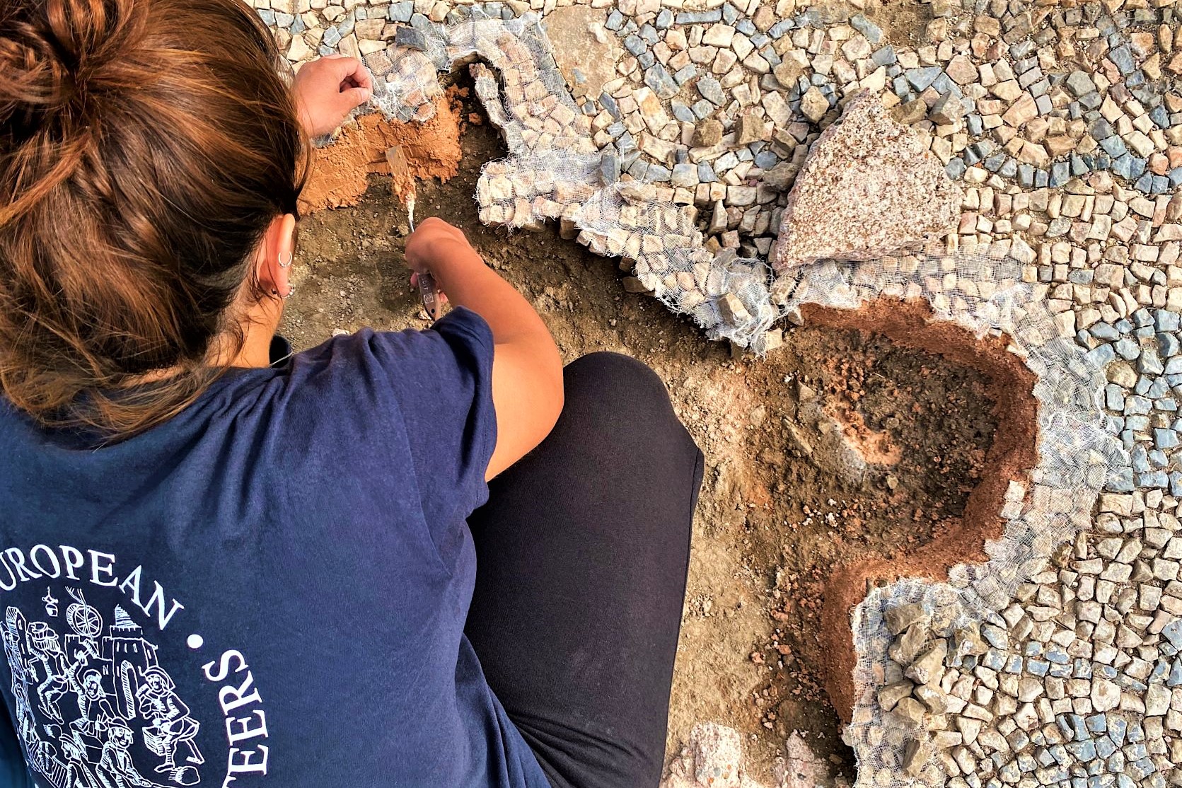 Participant working on delicate 4th century Roman mosaics at the Archaeological site of Ulpiana, Kosovo