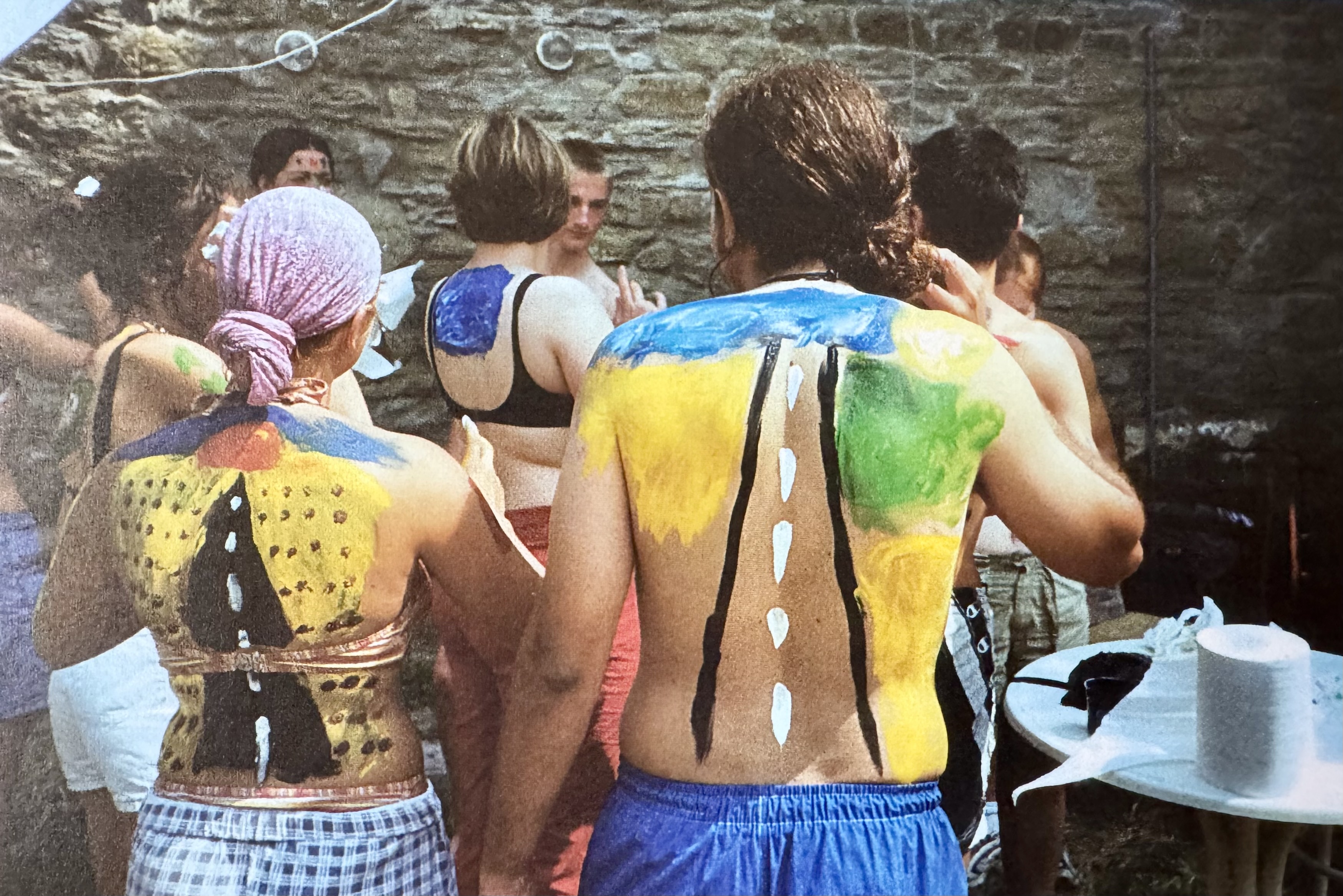 Volunteers animating a group activity with body painting, 2001