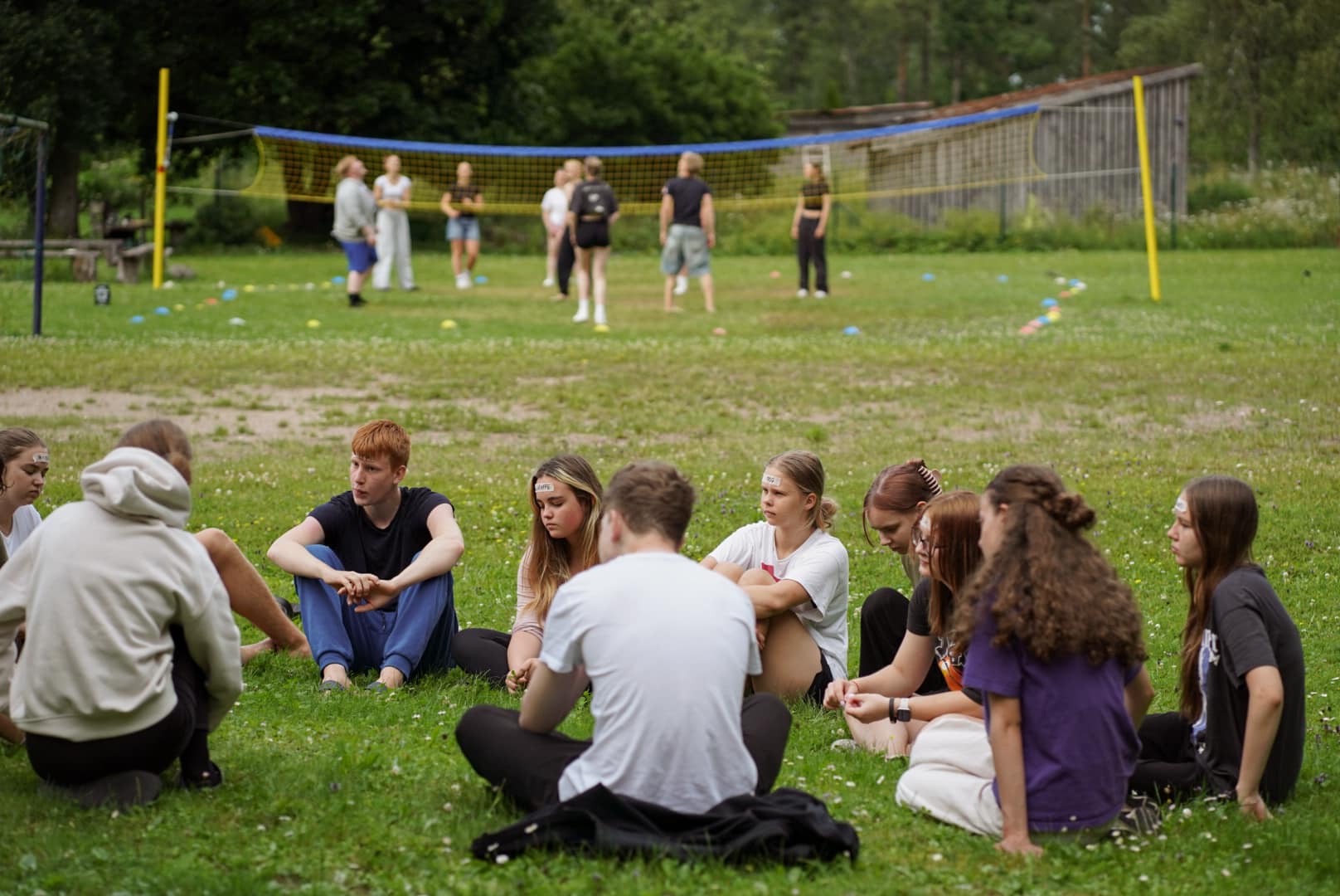 Young people sitting on the grass at the youth centre