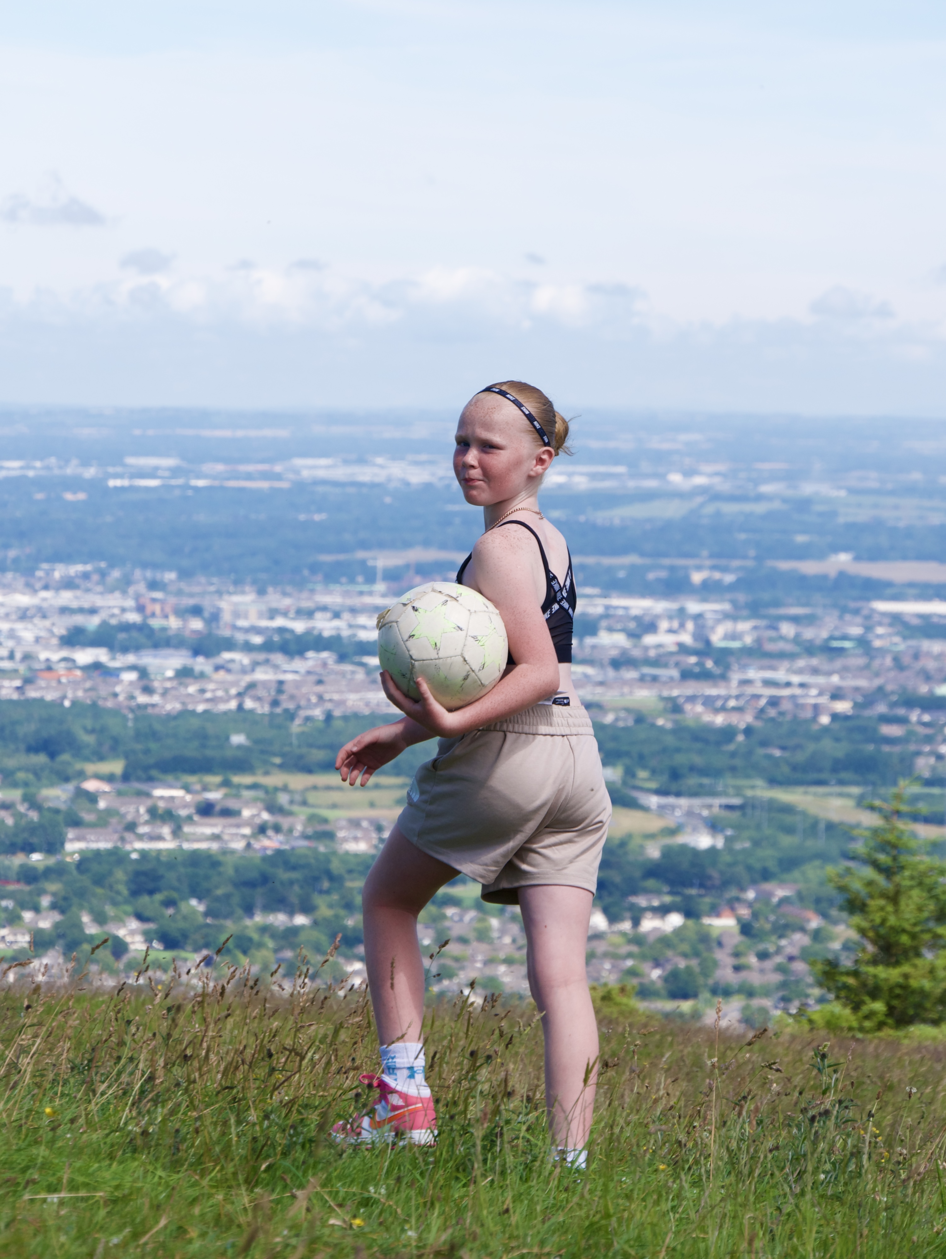 A young girl holding a football