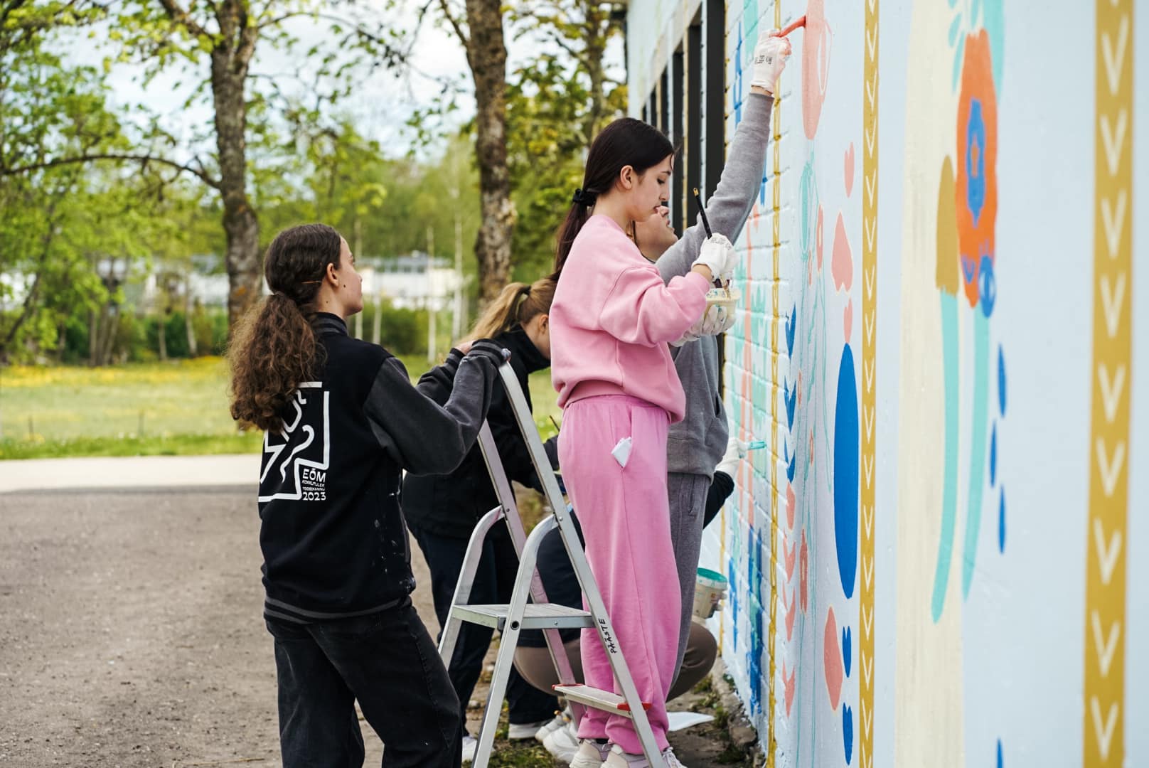 Young people painting a mural at the youth centre