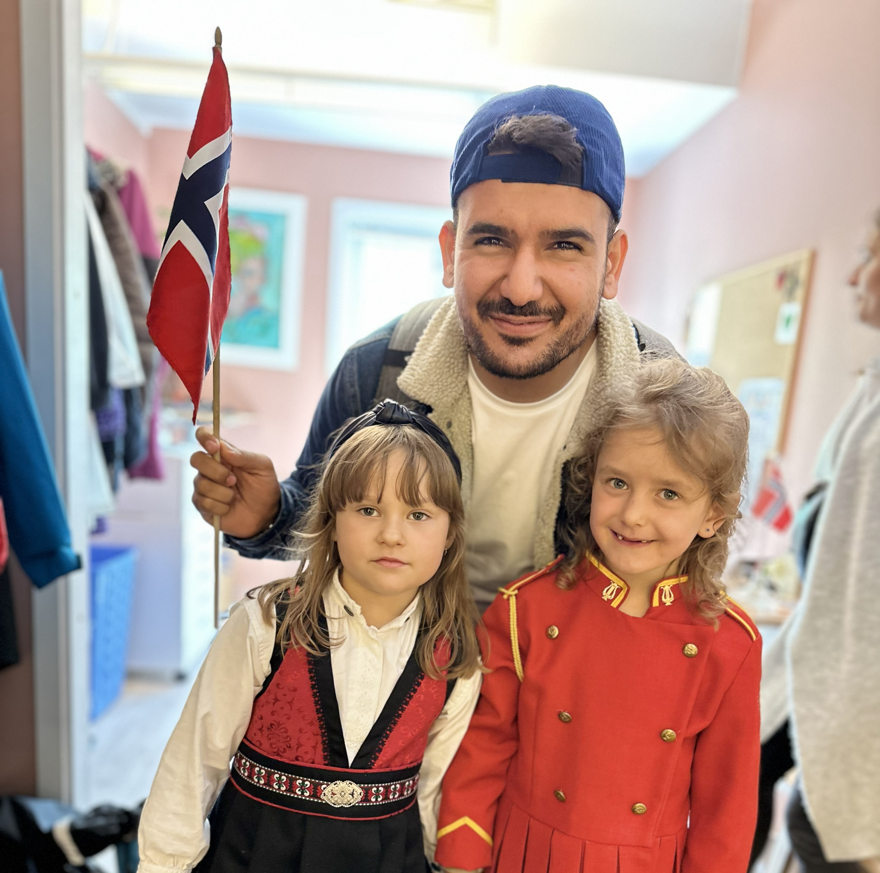Yunus Emre with two girls dressed in traditional clothing
