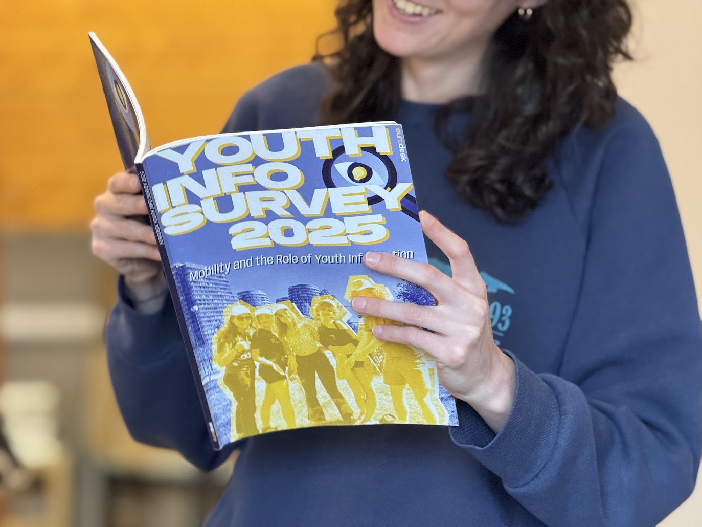 A person reading the Youth Info Survey 2025