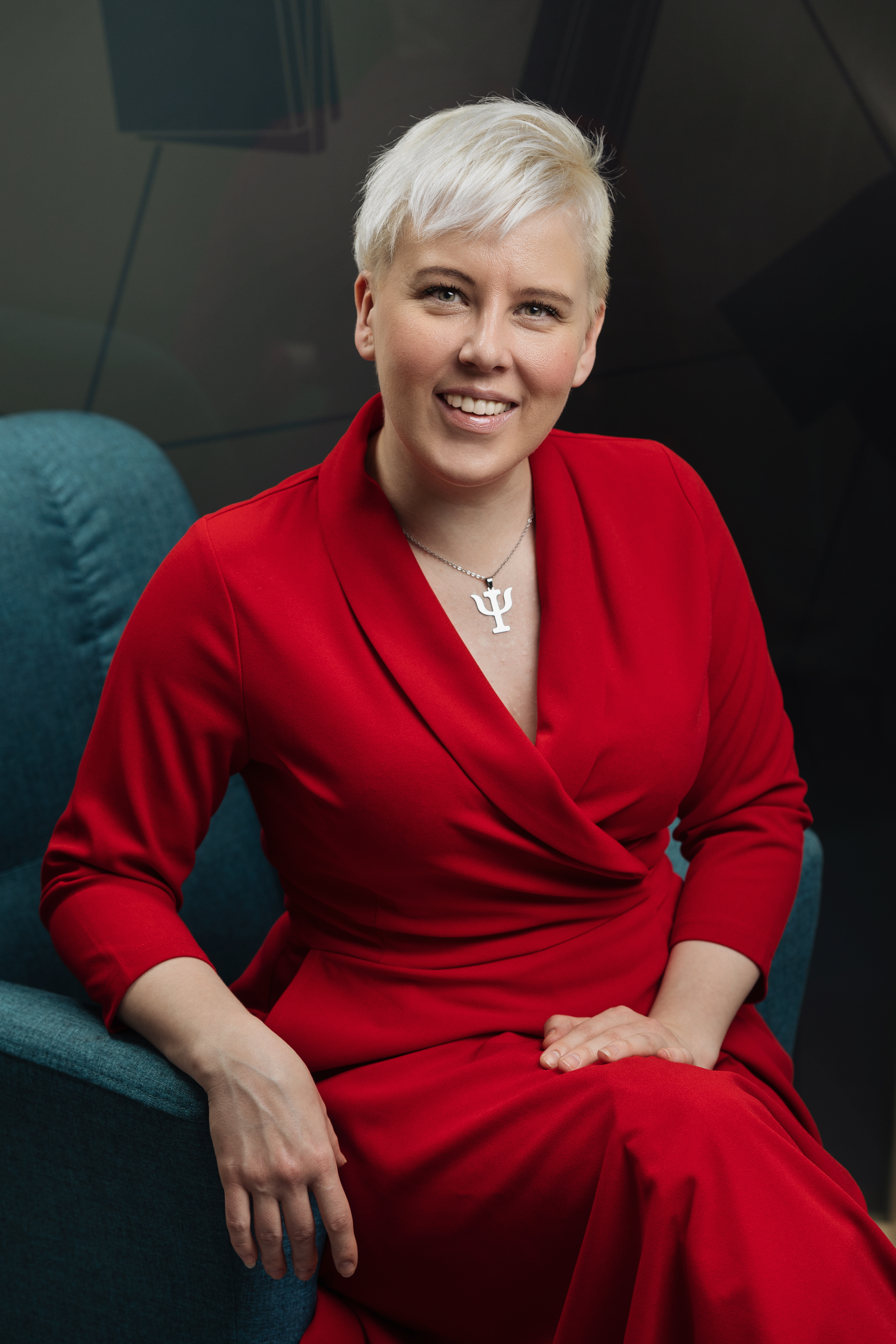 portrait picture of Helena Talihärm, Estonian psychologist. A female in a red dress.