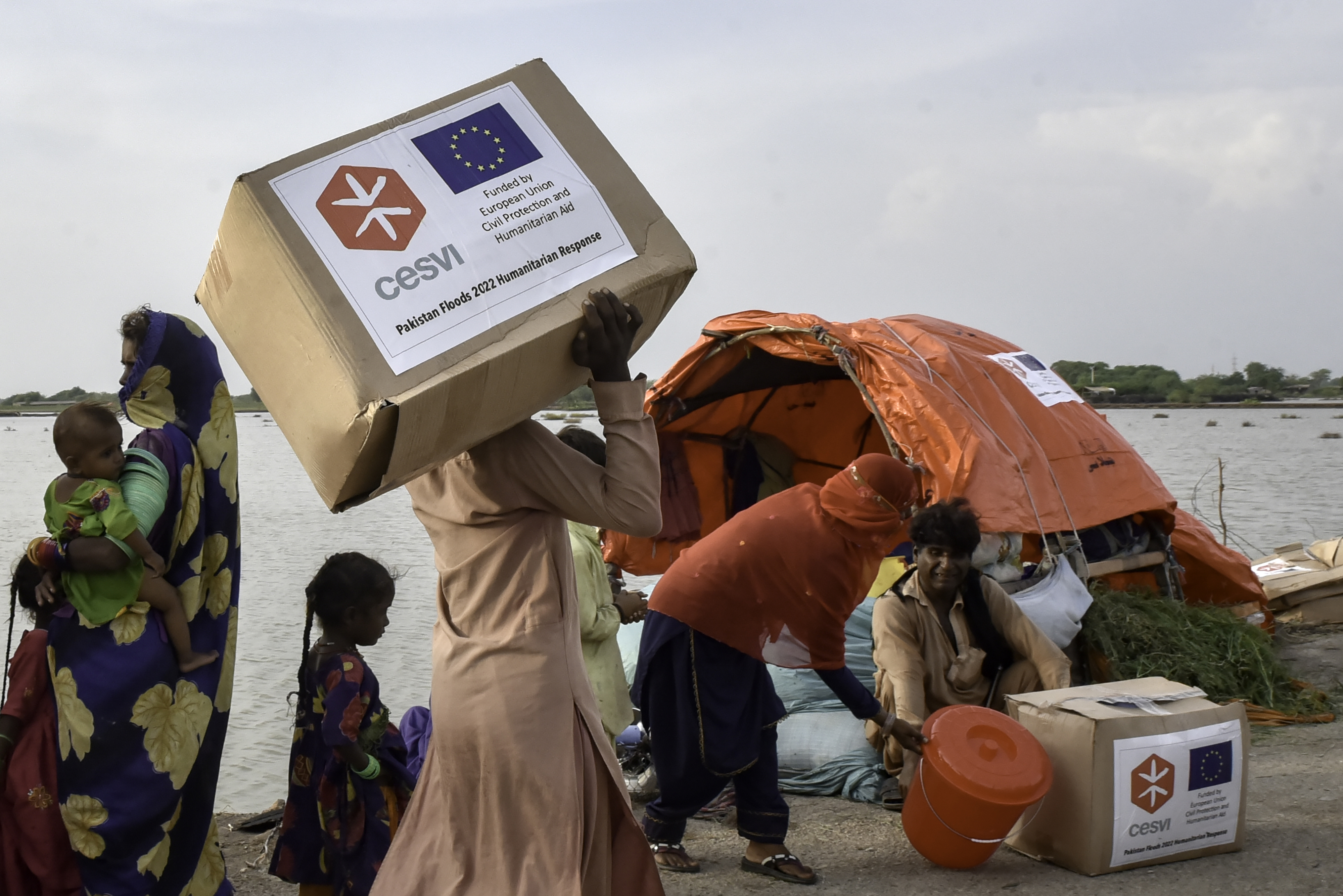 Flood-affected people from Hindu Community are going back to their makeshift tents after receiving relief supplies from a distribution center distributing under the supervision of Cecvi, funded by the European Union humanitarian Aid, here at Jhudo Union Council, European Union, 2022