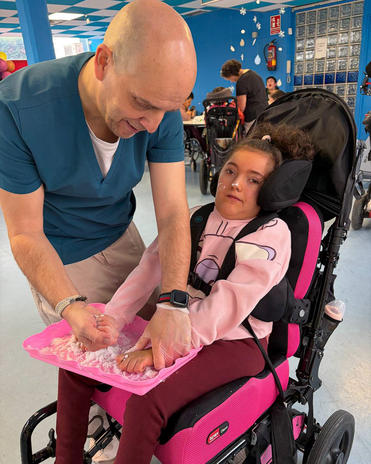 Girl in a wheelchair - Irene practising sensorial stimulation in School with Raúl.