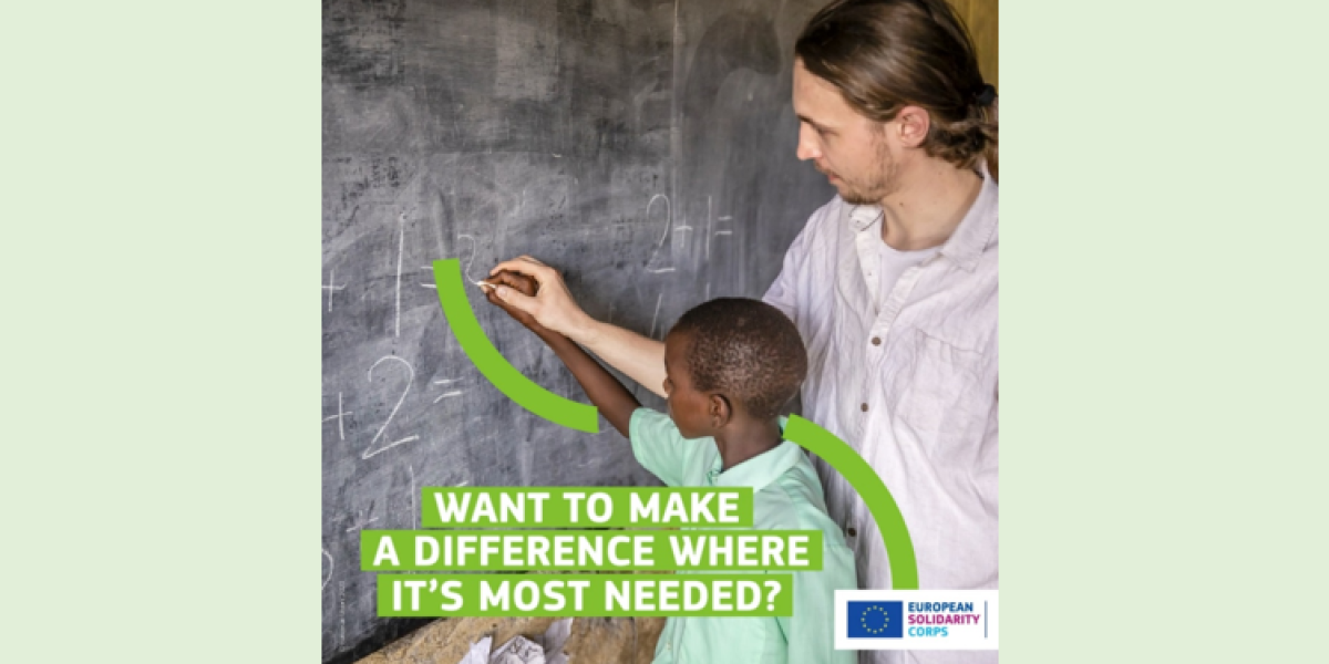 A young guy is doing maths with a kid and writing together numbers on a blackboard