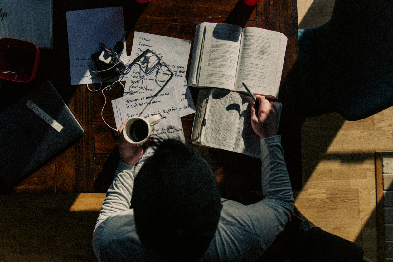 Man writing on white paper photo