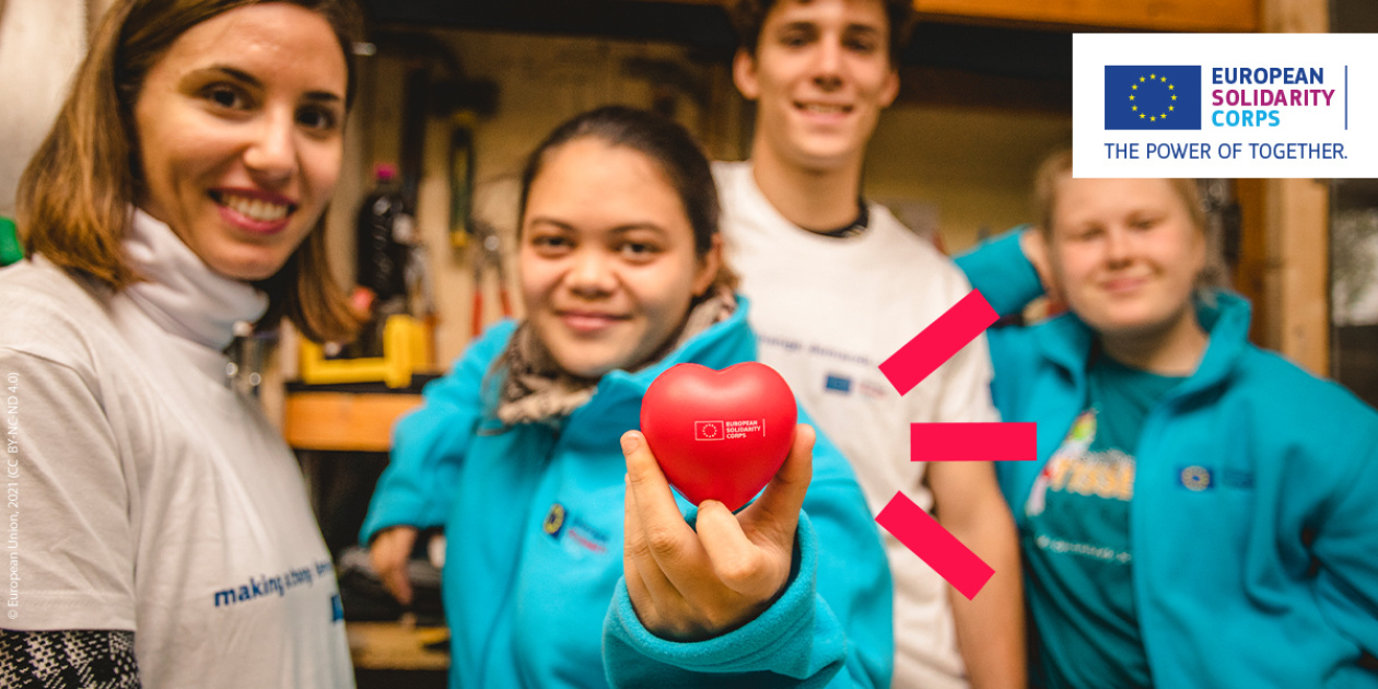 Young people taking part in a European Solidarity Corps project and one girl holding a hart