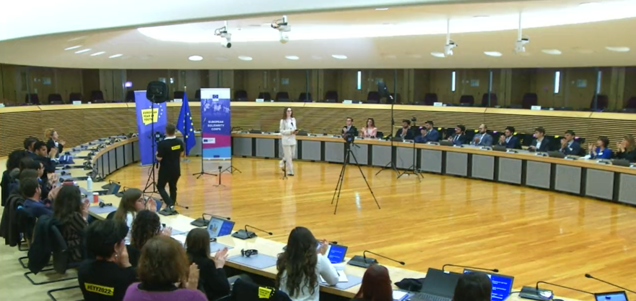 Picture of a Youth Talk - young people sitting in a room and listening to an inspiring speech from one of their peers. 