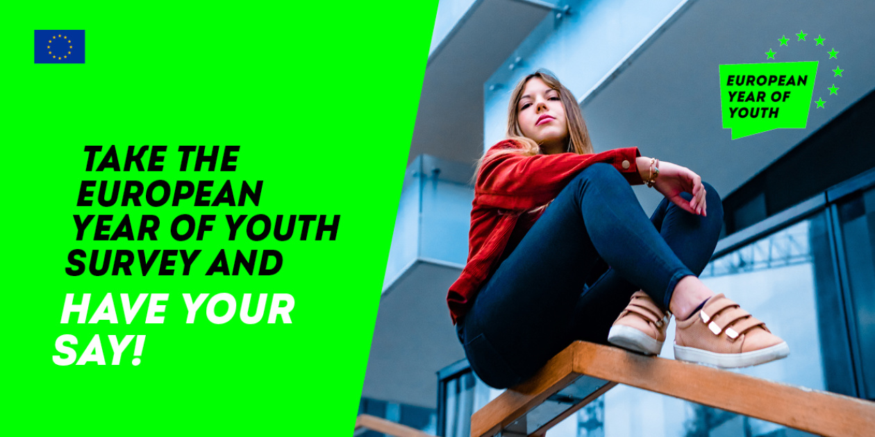 Young girl sitting and posing in front of a building