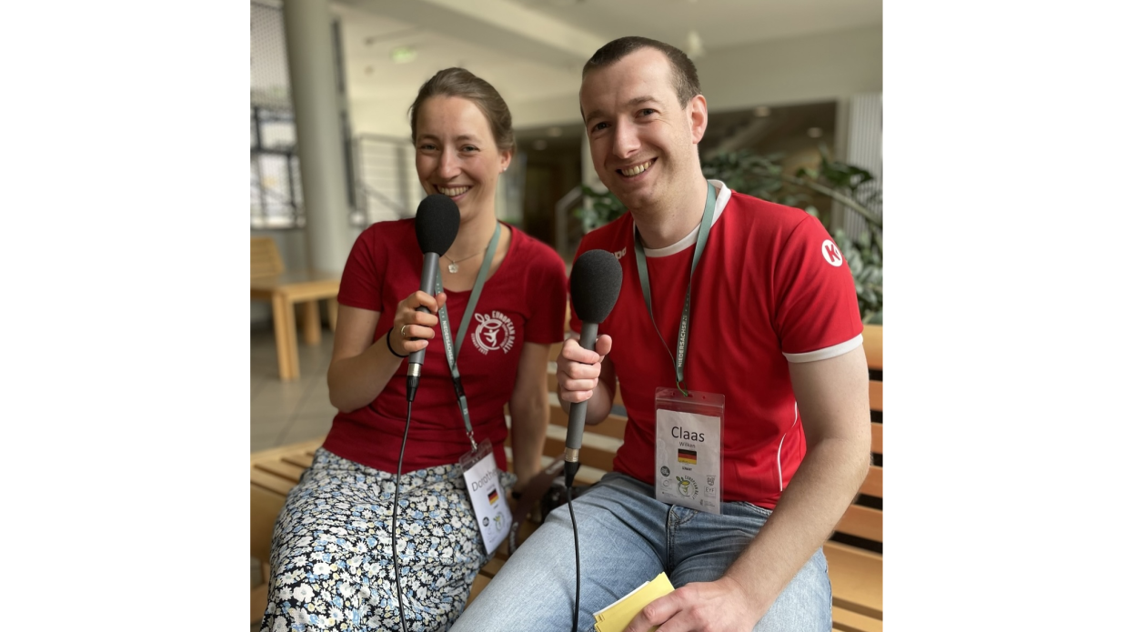 2 young people speaking with a microphone