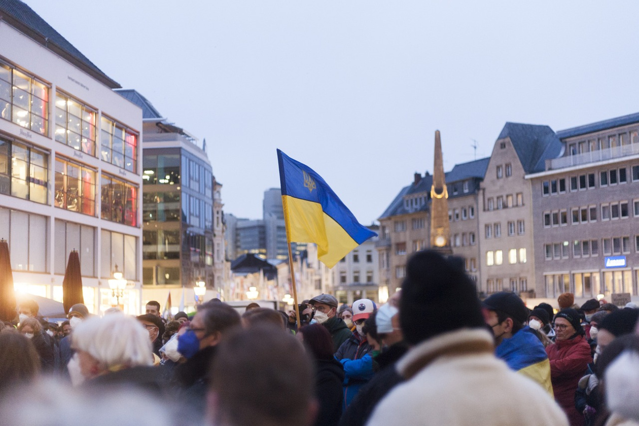 People in a square with the Ukrainian flag