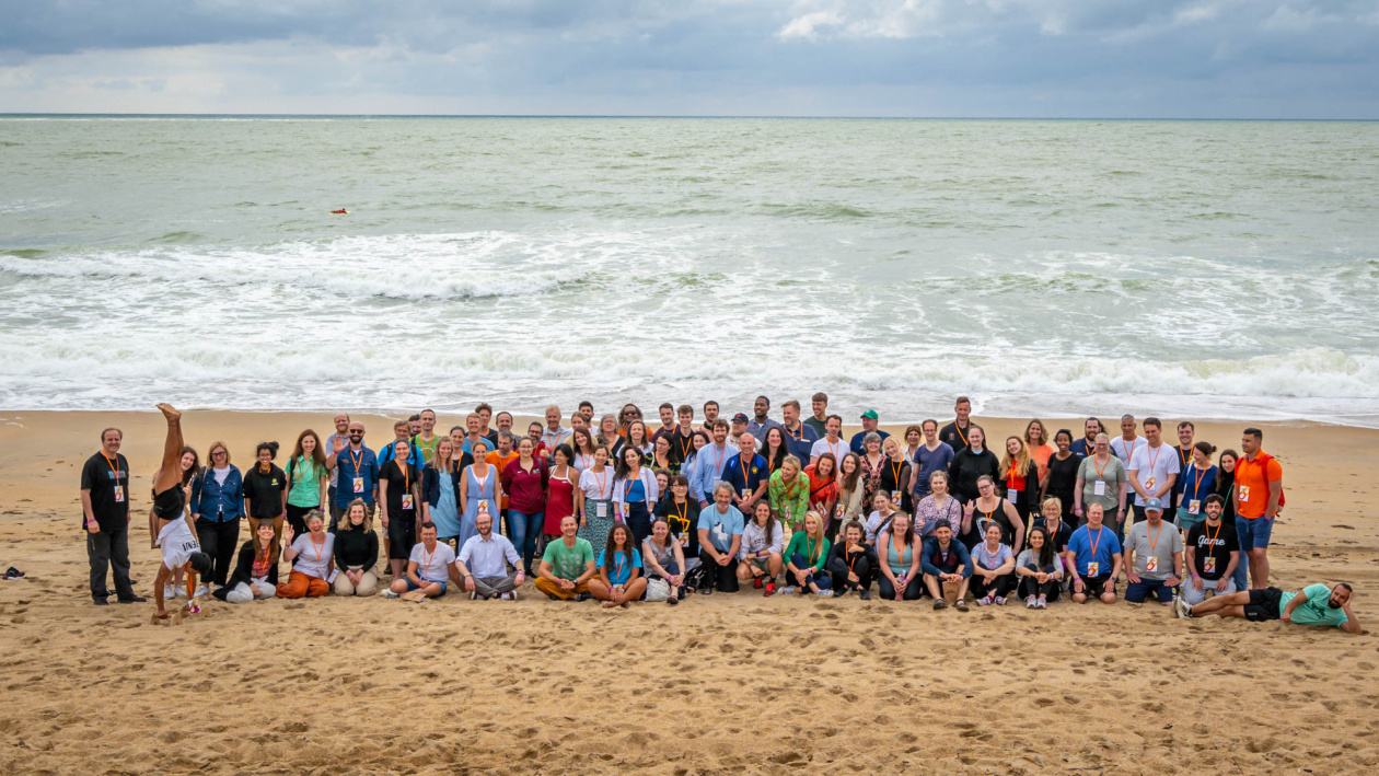 Group of people in the beach taking a picture near the sea