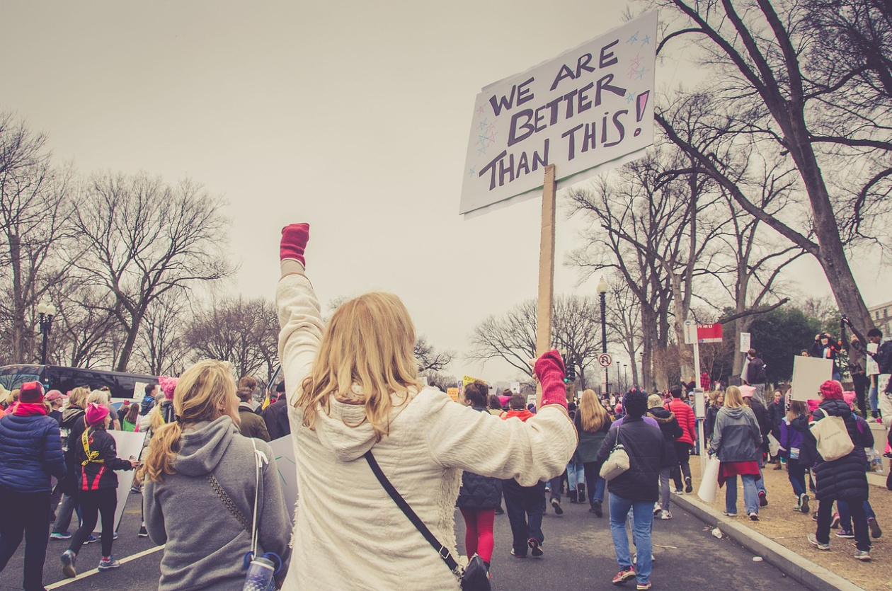 Woman and other people protesting in the street