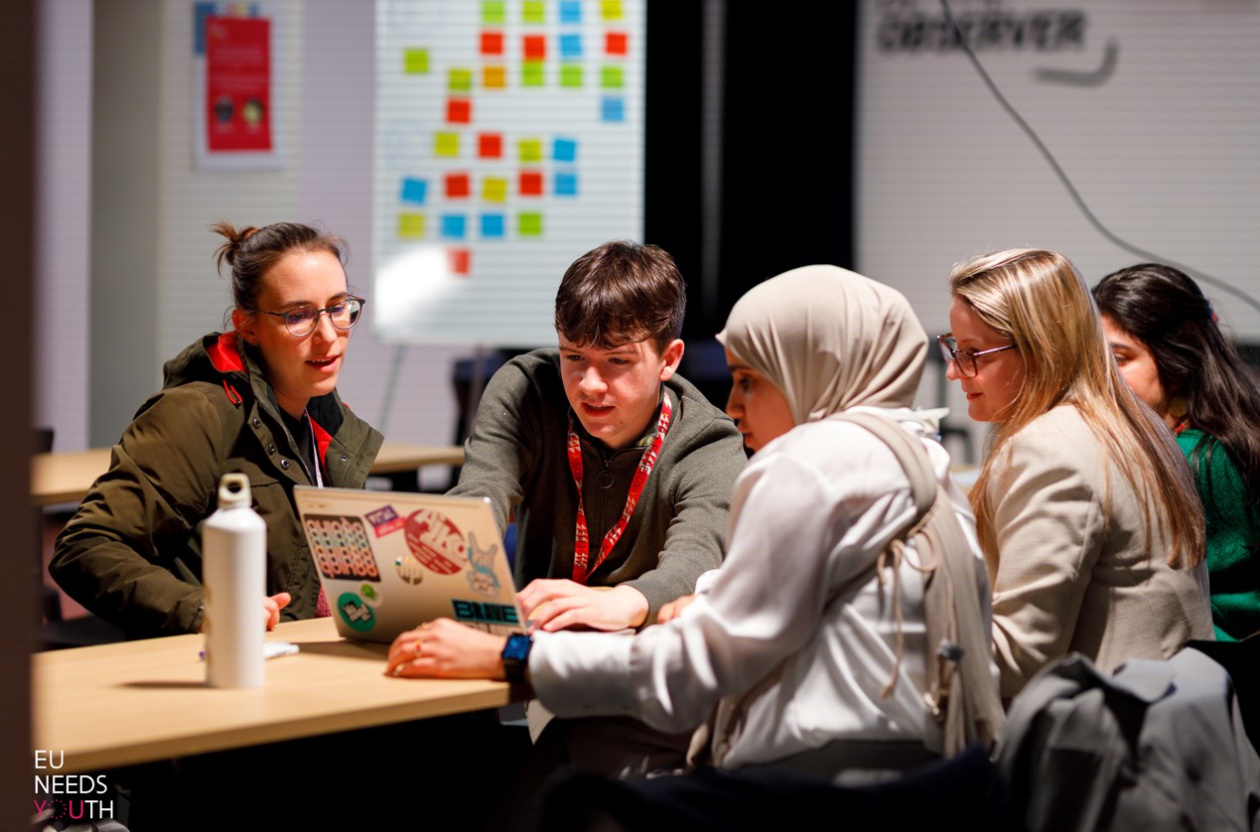 young people exchanging ideas around a table