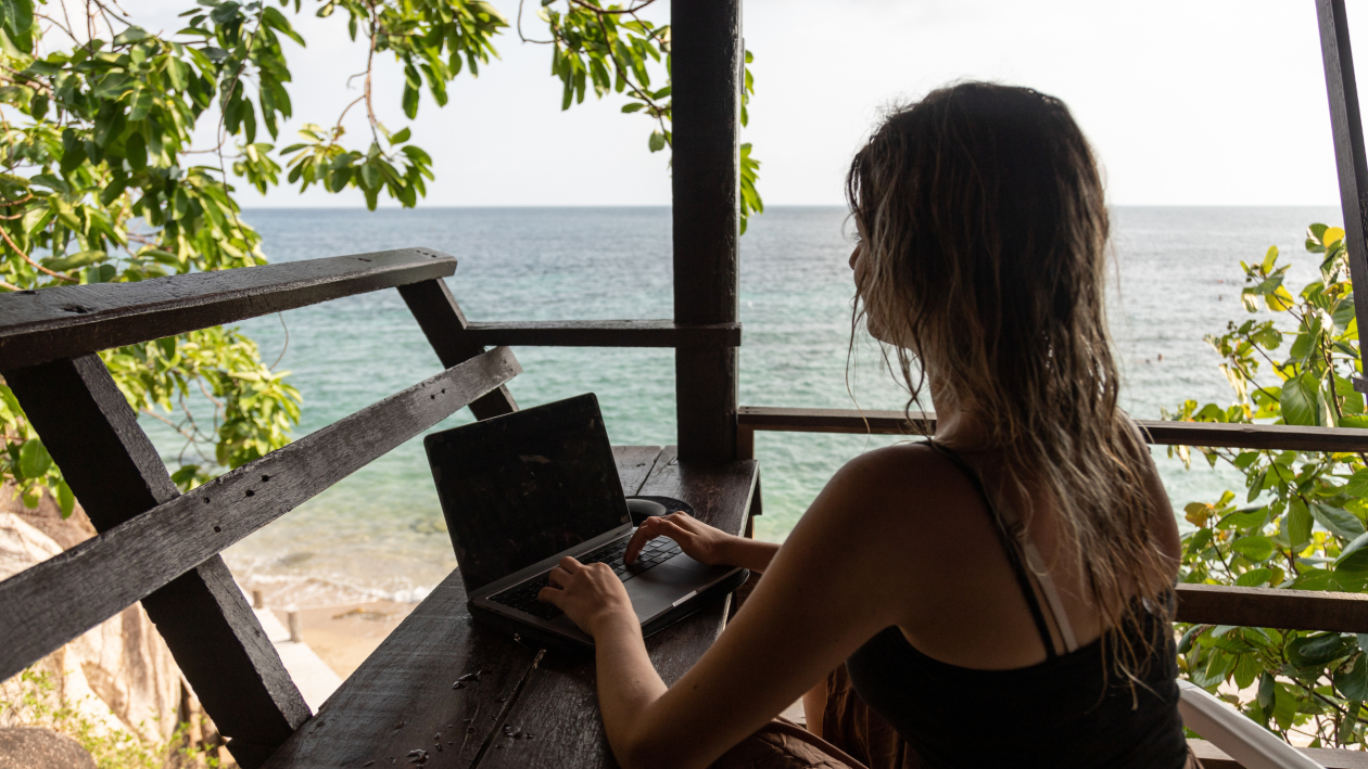 Female sitting outside, working on a laptop