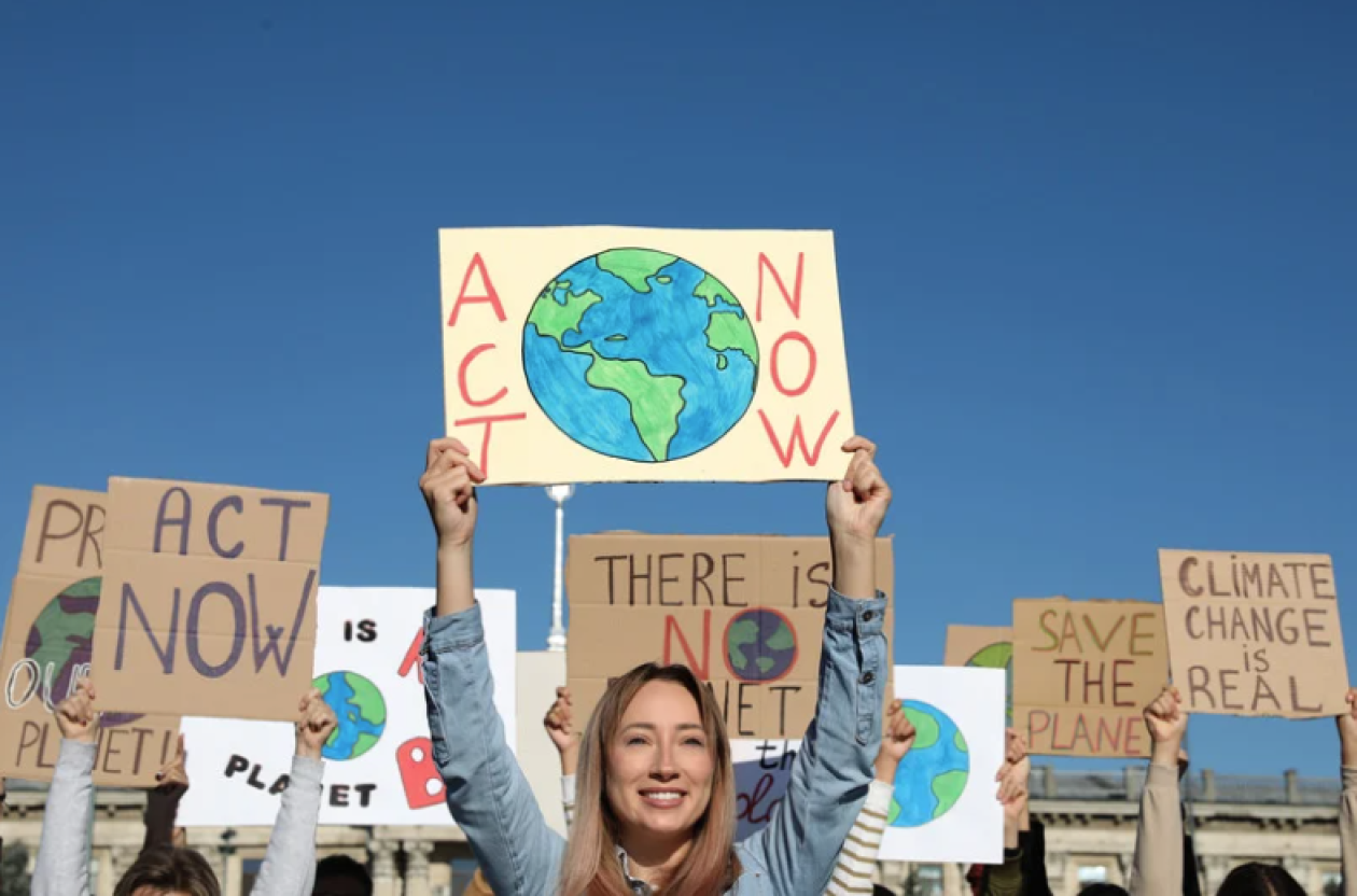 A group of young people holding posters protesting against climate change.