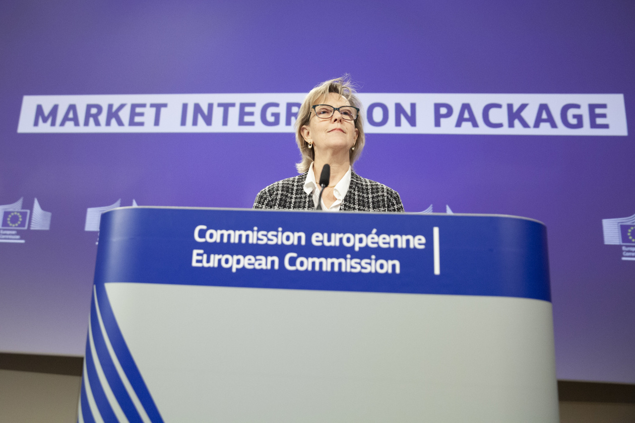 A person at a podium with the European Commission logo, in front of a “Market Integration Package” backdrop.