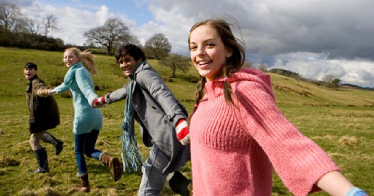Young people hand in hand in the nature