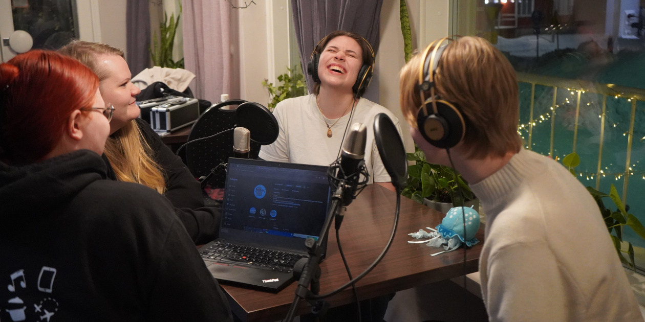 Four young people recording a podcast