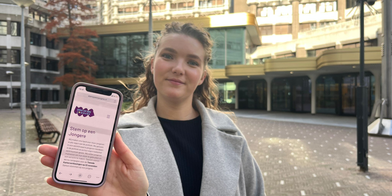 Young girl showing the project website on her cellphone