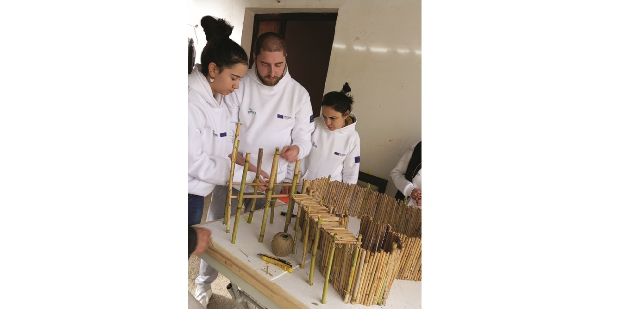 3 young people creating something manually on a table