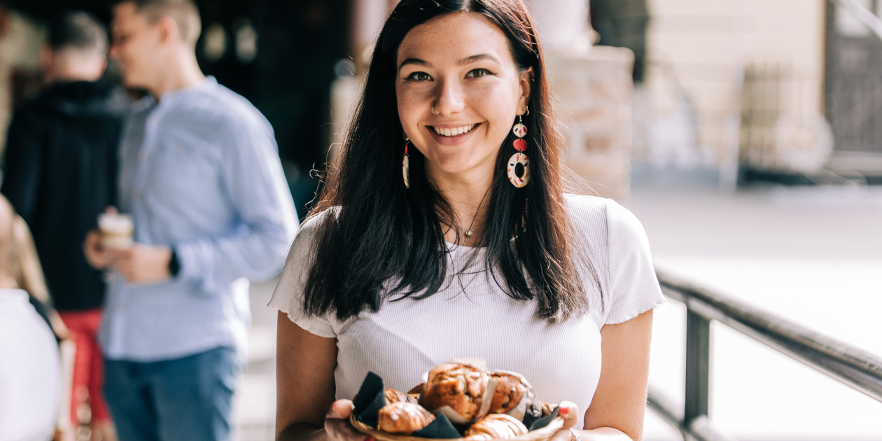 Young girl holding a plate of bakeries - Credit: MeOut