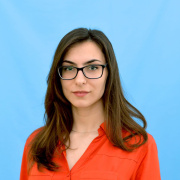 Young girl with brown hair and glasses