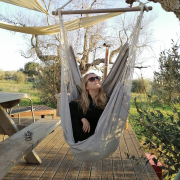 In the picture there is Teele sitting in a swing in Italy. 