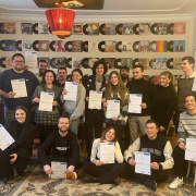 There is a group of young people holdimng youth passes in their hands as a group picture. 