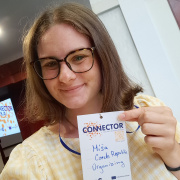 A girl holding a name tag. 