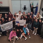 people in a training room, holding Erasmus+ flag