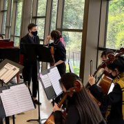 A girl sitting in an orchestra.