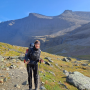A girl on a hike in the mountains.
