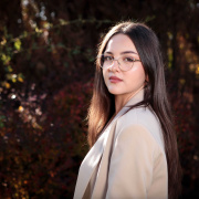 Young girl with brown hair and glasses