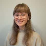 Alva looking into the camera smiling.