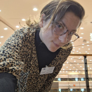 the girl, the author of this article looking at the camera, wearing glasses and has a long hair