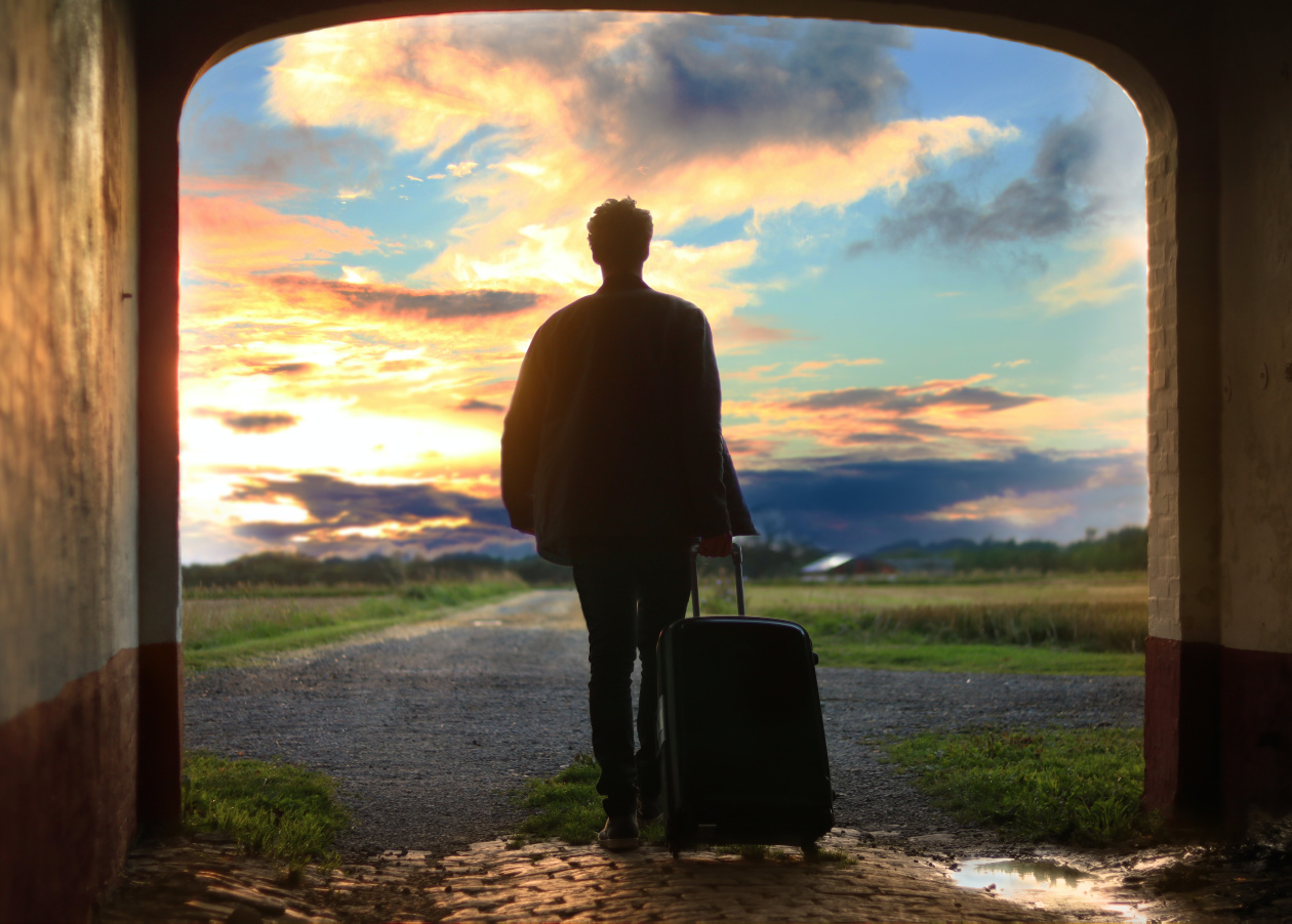 A person with a luggage walking. 