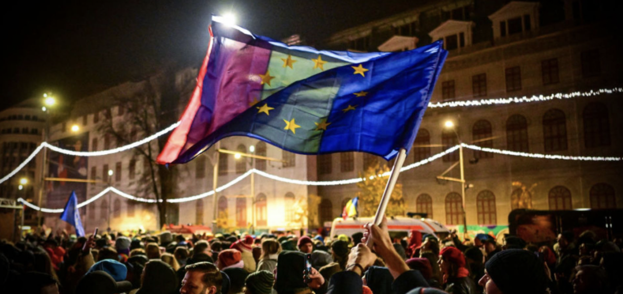 People wave Romanian and European Union flags during a pro-European rally in support of democracy at University Square in Bucharest, Romania