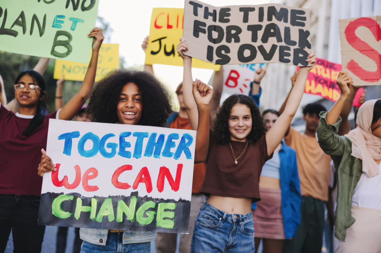 Young activists march with posters and banners as part of a global climate strike, protesting against climate change and global warming.