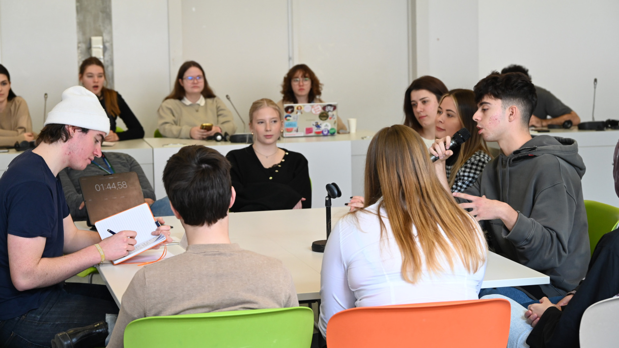 Young people debating around a table